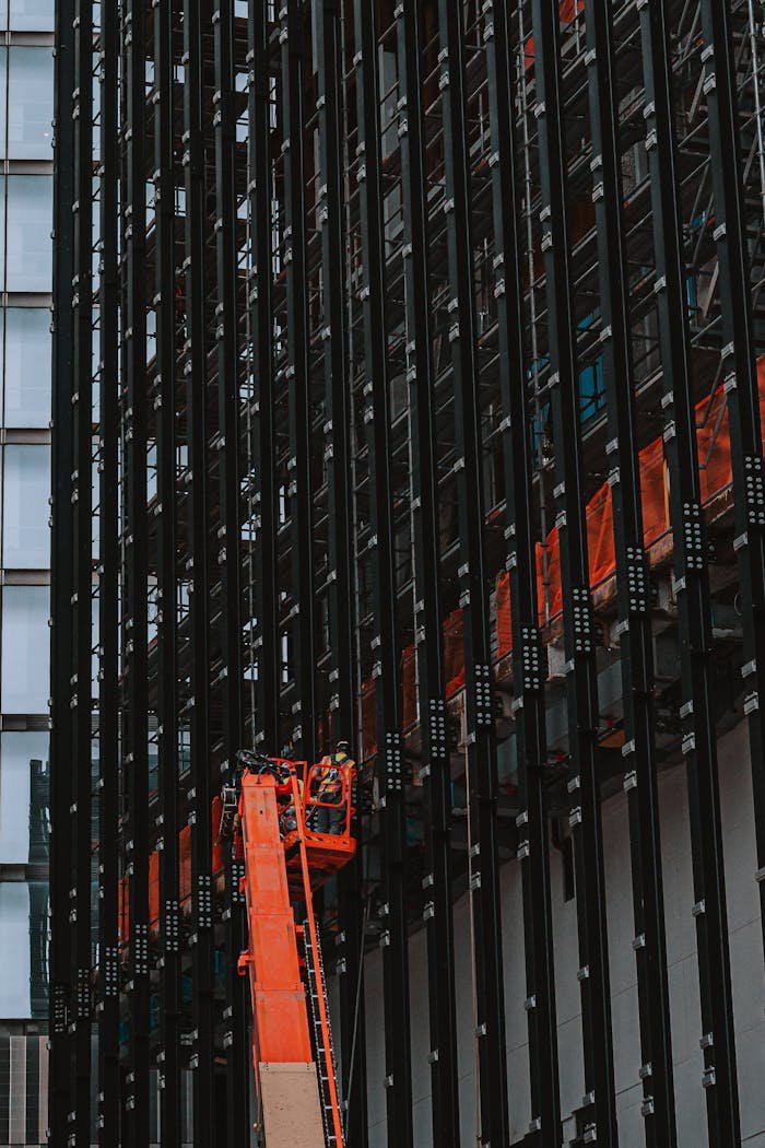 Elevated crane working on a modern skyscraper construction in New York City.